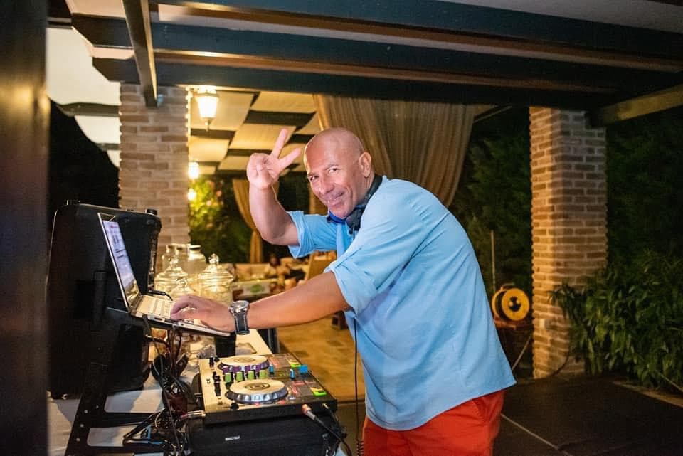 DJ Alex night setup with blue LED lights and neon sign