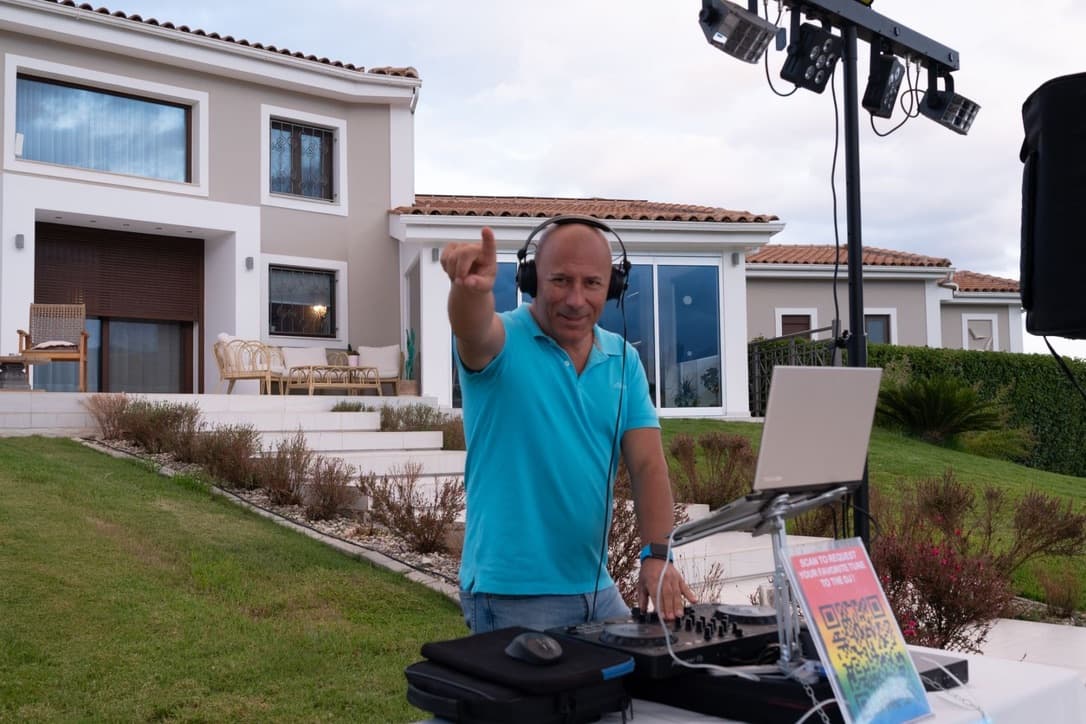 Couple at DJ booth during night wedding party